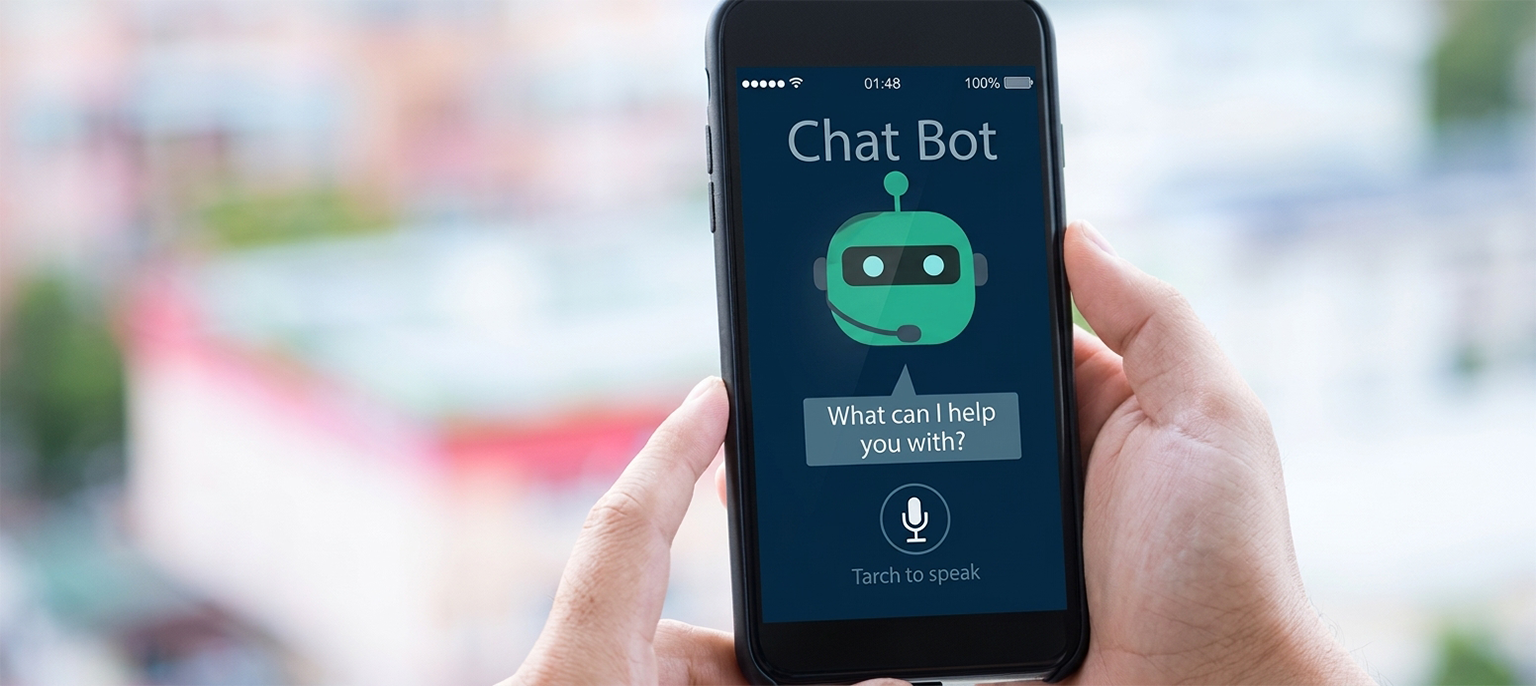 Hands holding a smartphone displaying a dark chatbot interface with a green robot avatar and voice search prompt against a blurred cityscape background, illustrating AI conversation tracking